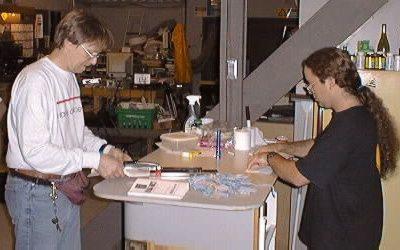 Mark and Karl laminating badges and folding conference programs